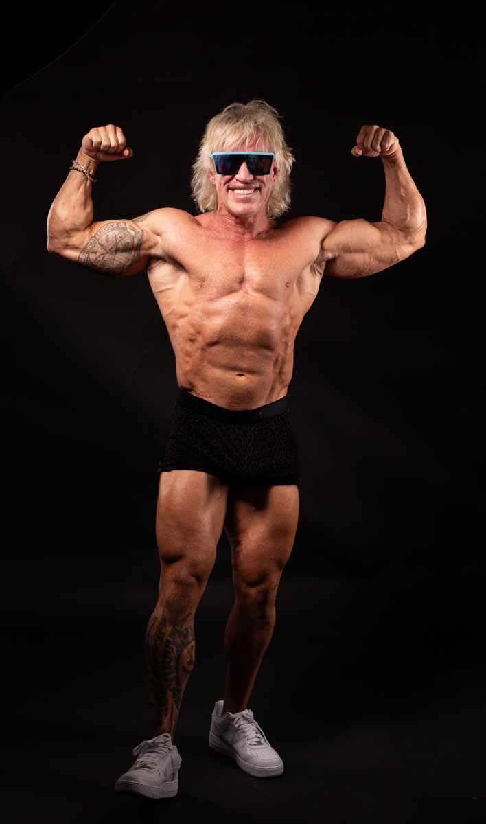 The coach is posing while wearing his sunglasses.